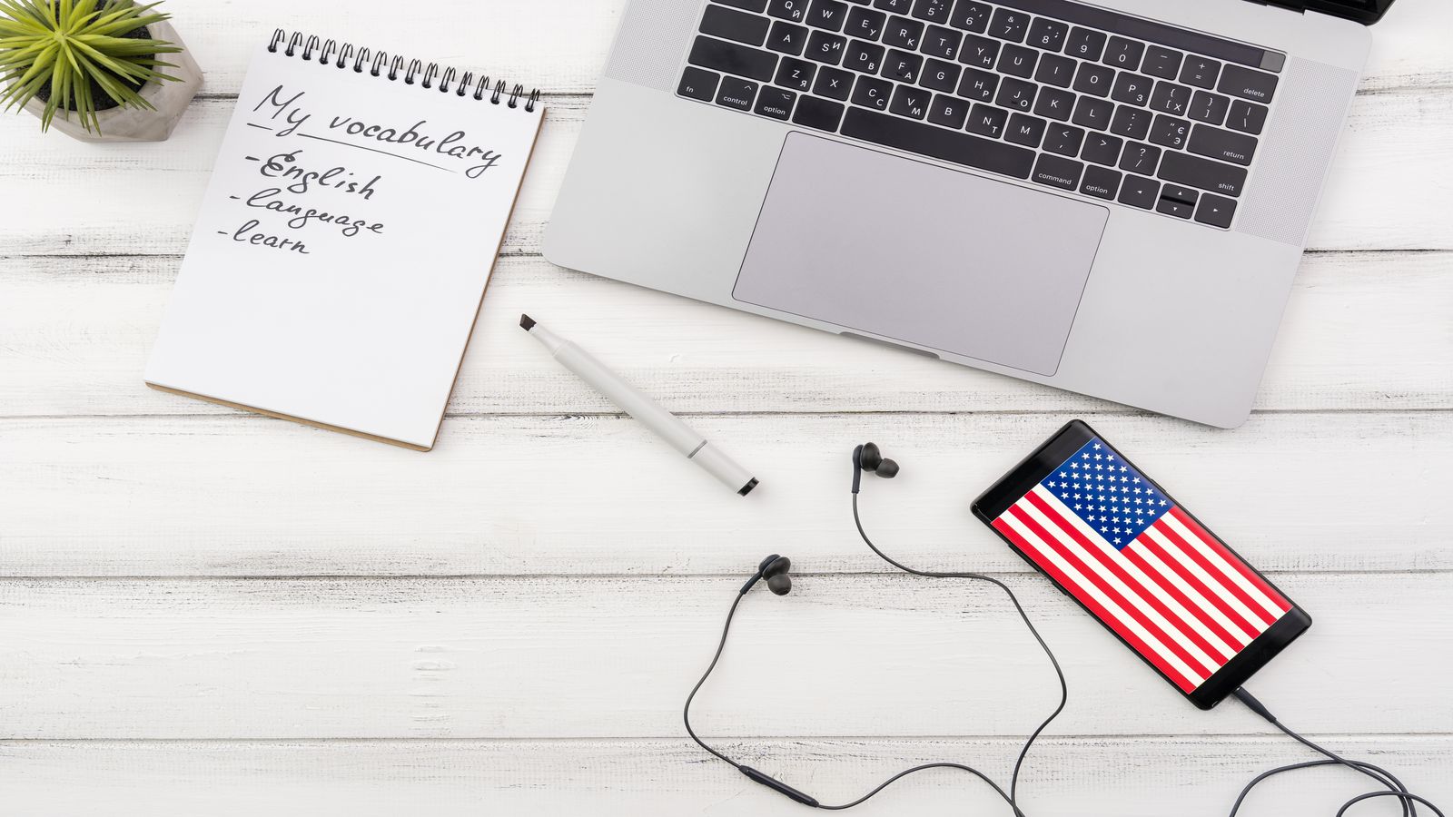 A creator's desk with a microphone, an open laptop showing a Lightning wallet dashboard, and a printed checklist of monetization options pinned to a corkboard