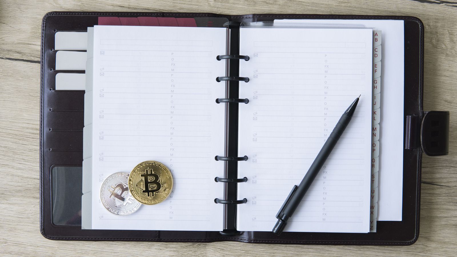 A hardware wallet resting on a table next to a sealed envelope, representing the physical reality of self-custody decisions
