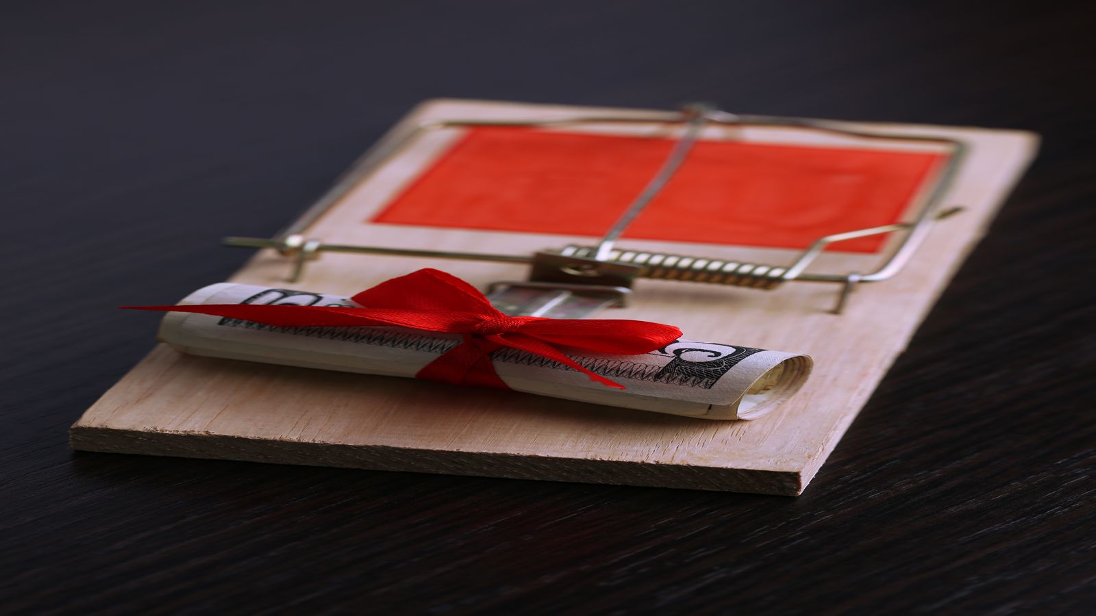 A sealed envelope resting on a writing desk beside a pen and a small safe, representing the practical preparation of a letter of instruction