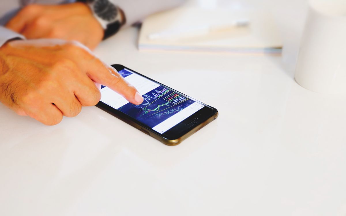 A split view showing a hardware wallet screen displaying a receive address and a laptop screen showing the same address on an exchange withdrawal form, emphasizing address verification