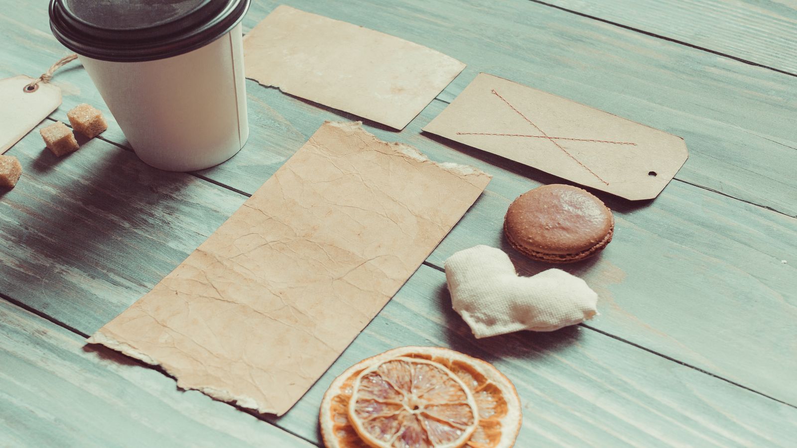 An open laptop beside a notebook and a pair of headphones on a clean desk, representing the act of staying connected to independent Bitcoin content