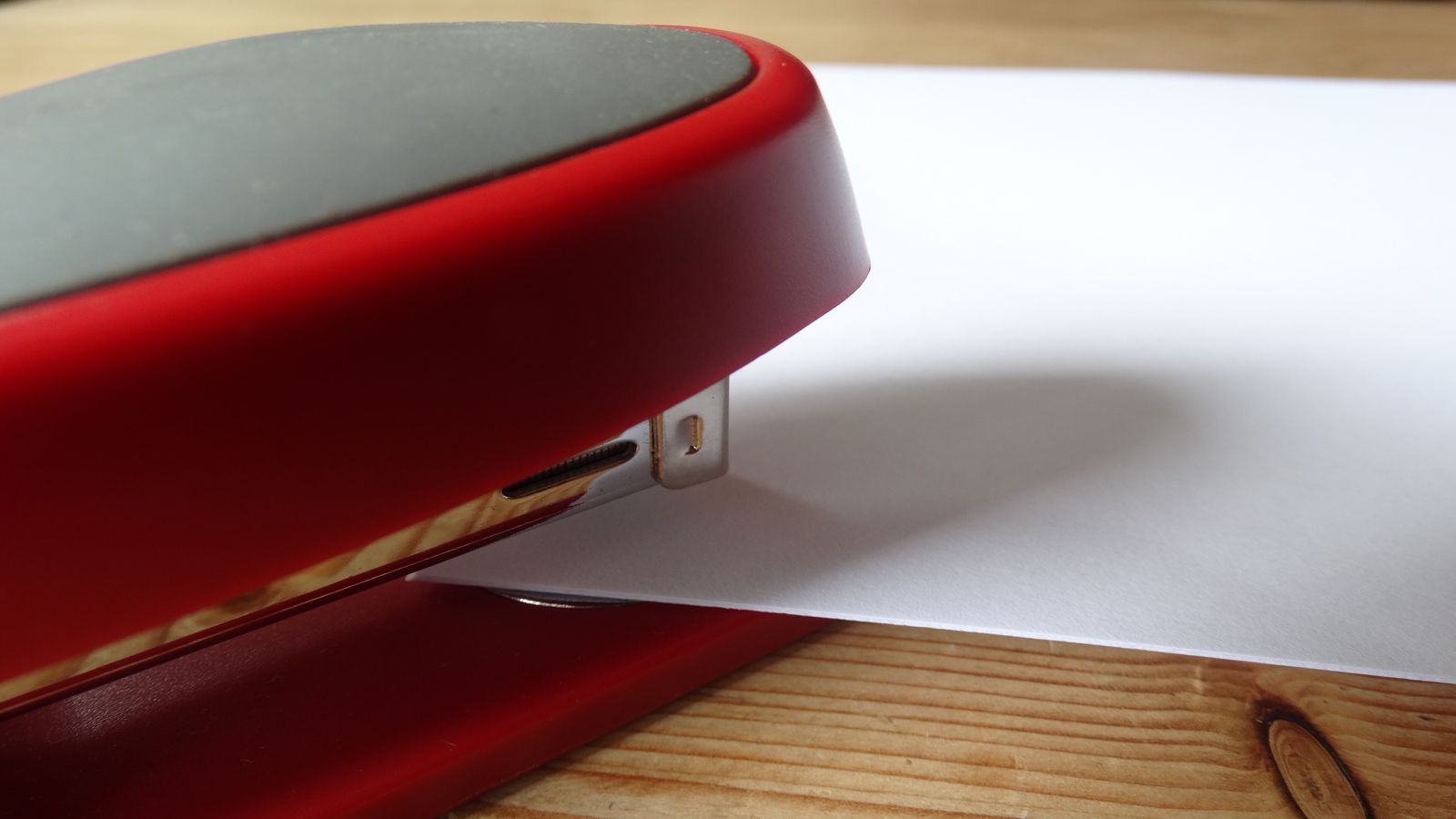 A neatly arranged desk with a printed document, a pen, and reading glasses, representing a careful review of written terms